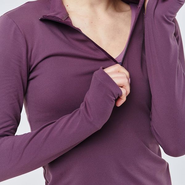 Smiling woman in comfortable activewear looking relaxed.